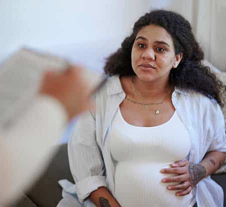 Pregnant woman talking to healthcare professional